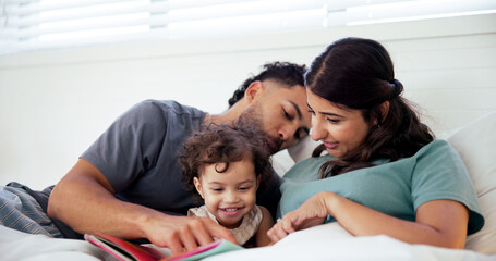 Obraz premium Reading, book and parents with toddler in bed at home together for bonding in morning on weekend. Happy, love and girl baby relaxing with mother and father for storytelling in bedroom at house.