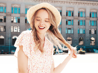 Beautiful smiling brunette model. Trendy female posing in the street background. Funny and positive...