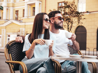 Smiling beautiful woman and her handsome boyfriend. Happy cheerful family. Couple drinking...