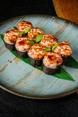 Sushi rolls with creamy toppings and vibrant greens create a delicious culinary delight