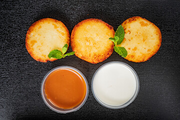 Fried dough circles with creamy sauces and fresh mint leaves showcase vibrant flavors
