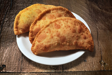 cheese and meat empanadas on white plate