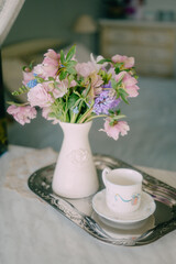 Delicate spring bouquet in a home interior in pink shades