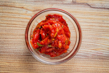 Vibrant red salsa made from tomatoes and spices, promising a delicious meal ahead