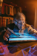 Obraz premium Elderly person interacting with a floating holographic photo album