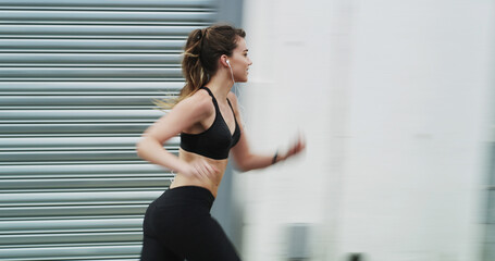 Fototapeta premium Running, fitness and woman on street, city and practice for marathon in morning, exercise and blurred. Healthy, runner and person on road for workout, athlete and training with energy for sports