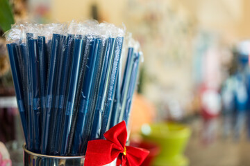 Stock straw on bar counter in coffee shop. Self service in coffee shop. Blue drink tubes