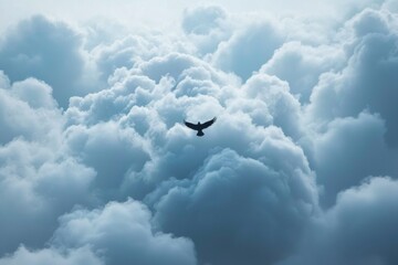Bird flying above puffy, white clouds in a blue sky for freedom concept