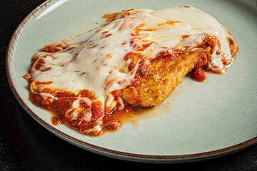 Tasty chicken topped with rich marinara and gooey cheese invites indulgence
