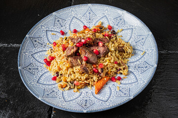 Delicious rice dish showcases succulent meat and fresh pomegranate seeds, highlighting rich flavors