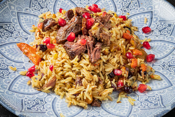 A flavorful rice creation adorned with succulent beef and bright pomegranate
