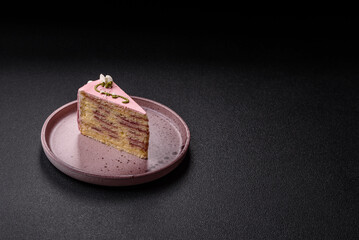 A piece of pink layered cake with strawberry flavor