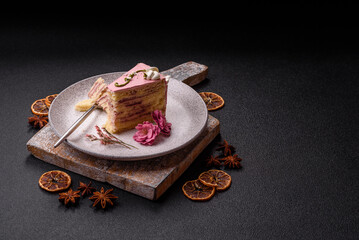 A piece of pink layered cake with strawberry flavor