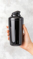 Minimalistic fitness lifestyle focusing on a hand holding a protein shaker bottle