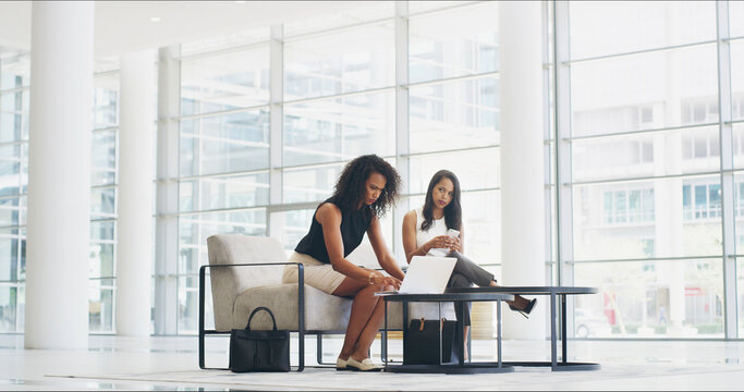 Laptop, meeting and conference with business people in lobby for seminar, keynote speaker schedule and search. Convention, corporate and planning with women in waiting room for company event