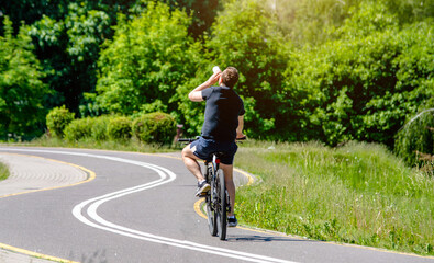 Cyclist ride on the bike path in the city Park
