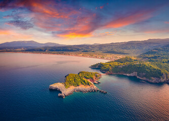 Attractive summer sunset on Saint Basil Beach with Agkali village on background, Nileas, Greece,...