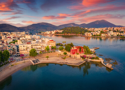 Astonishing summer cityscape of Chalcis town. Impressive sunrise on Aegean sea, North Euboean Gulf. Superb morning scene of Euboea island, Greece, Europe. Traveling concept background.
