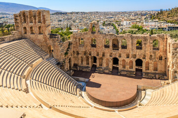 A large, empty amphitheater with a view of the city, the Acropolis of Athens