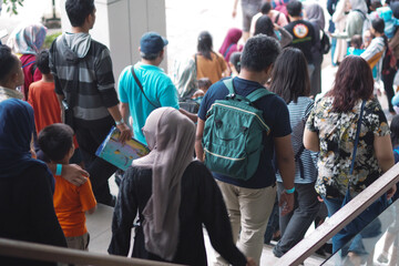 seen from behind people coming down stair