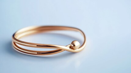Elegant gold bracelet on a light blue surface