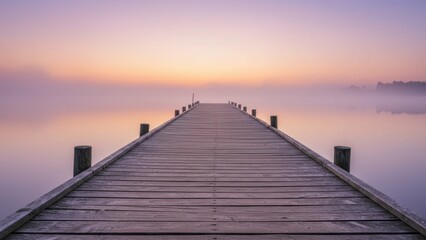 Fototapeta premium Wooden pier stretches into foggy water under a serene sunset sky, Calm lake reflects soft, pastel colors, creating peaceful, ethereal scene with nature,