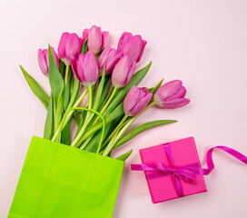 Fototapeta premium Mother day gift. Tulip flower bunch on pastel pink. Fresh flowers bouquet. Spring