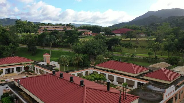 Drone view of UPR - University of Puerto Rico in Utuado surrounded by green spaces and lush hills