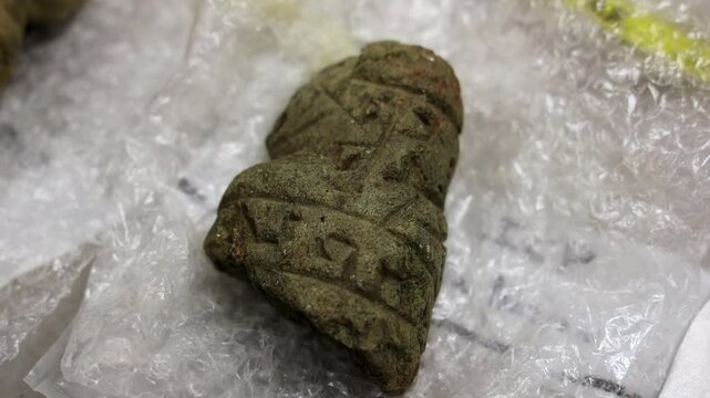 Closeup of a stone with Taino Symbols dig up in archaeology