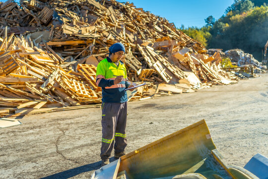 Man standing outside a wood section of recycling plant