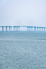 Obraz premium Minimalist Sea and Bridge Landscape with Clean Lines Minimalist seascape with bridge structure crossing calm water. Clean lines and fresh blue tones create a modern aesthetic background.