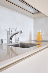 Modern kitchen with sleek design and refreshing beverage on the countertop