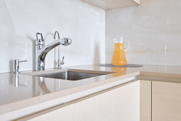 Modern kitchen setup with a sleek design and refreshing beverage for summer enjoyment