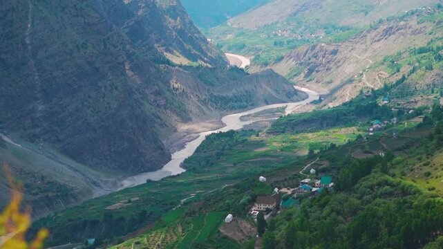 ChandraBhaga river flowing between the Himalayan mountains of the Pattan Valley as seen from Marbal village in Lahaul and Spiti district, Himachal Pradesh, India. Scenic view of river in Lahaul valley