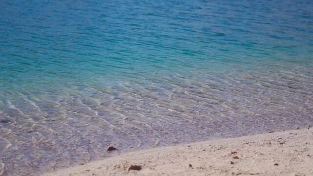 Closeup slow motion shot of water ripples on the blue colored clear water of the Chandra Taal Lake at Lahaul and Spiti district, Himachal Pradesh, India. Beautiful alpine lake in the Himalayas.