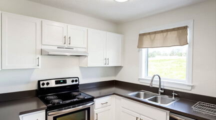 Fototapeta premium modern kitchen with stainless steel appliances and white cabinets