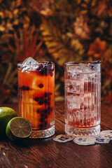 beautiful cocktails in warm colors on a flower background. cocktail or bar menu concept.