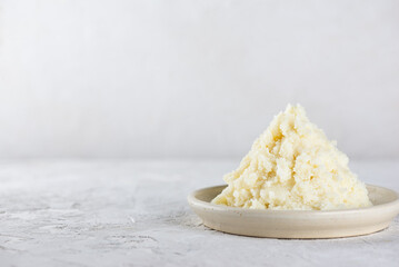 Edible shea butter in a plate on light table. Copy space.