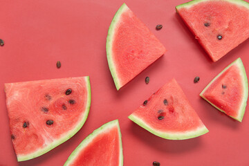 Composition with pieces of ripe watermelon on red background