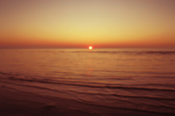 sunrise or sunset on the sea in summer defocus. blurred sea background