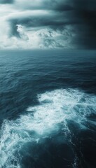 Fototapeta premium Astonishing aerial perspective of deep ocean waters and clouds in a dark apocalyptic setting