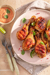Tasty roasted chicken leg with mustard sauce and lime.