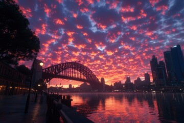 Obraz premium Sydney Harbour bridge at sunrise, vibrant clouds, city skyline, tourism backdrop