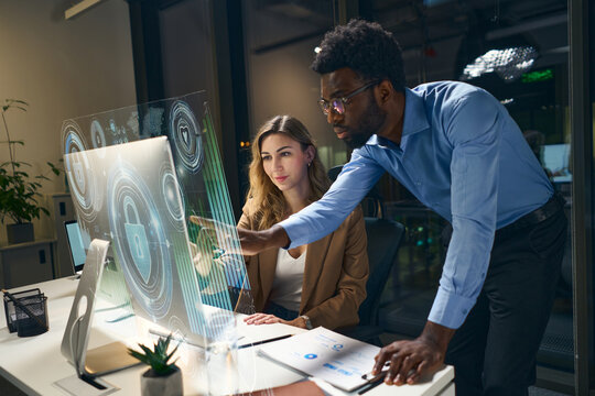 Team Collaborating On High-Tech Screen Analyzing Data Visualization And Security Interfaces