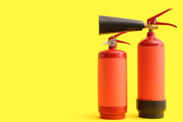 Fire extinguishers on yellow background