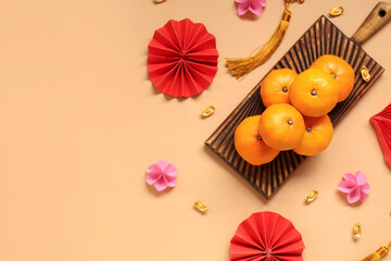 Mandarins and Chinese symbols on beige background. New Year celebration
