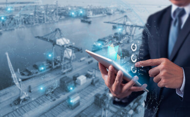 Businessman using digital tablet with futuristic interface to monitor logistics, shipping, and...