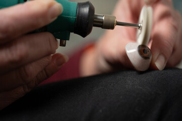 Ocularist polishing prosthetic eye with rotary tool