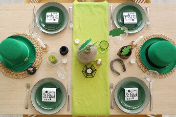 Festive table serving with leprechaun's hat and decorations for St. Patrick's Day celebration, top...