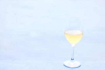 a glass of white wine on the background of the sea relaxing by the sea with wine